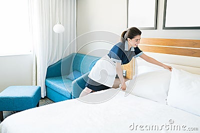 Smiling Maid Cleaning Hotel Room Stock Photo