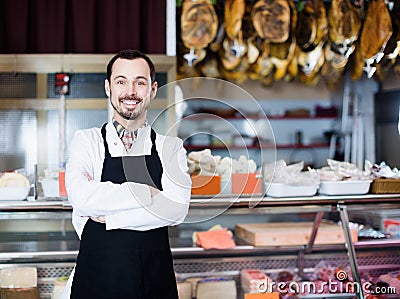 Smiling male assistant working with meat Stock Photo