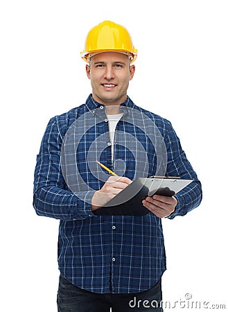 Smiling male builder in helmet with clipboard Stock Photo