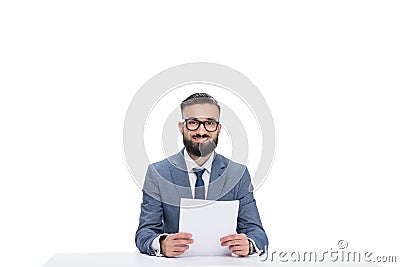 smiling male newscaster with papers looking at camera, Stock Photo