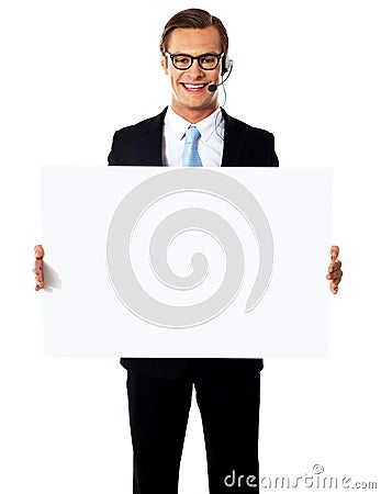 Smiling male operator with blank billboard Stock Photo