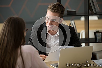 Smiling male recruiter discussing cv with female job applicant Stock Photo