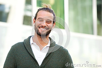 Smiling man with beard wearing green sweater Stock Photo