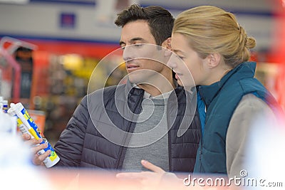 Smiling man customer buying sealing component in household shop Stock Photo