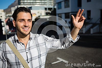 Smiling man gesturing while standing on city street Stock Photo
