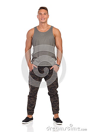 Smiling Man In Gray Tank Top And Camo Pants Stock Photo