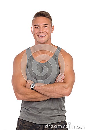 Smiling Man In Gray Tank Top Posing With Arms Crossed Stock Photo