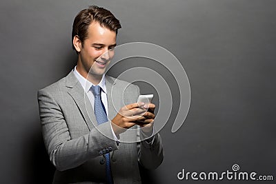 A smiling man with a handphone isolated Stock Photo