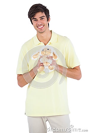 Smiling man holding a sheep plush Stock Photo