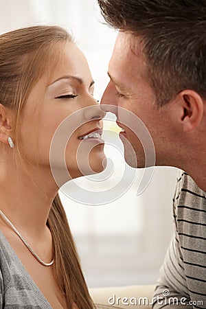 Smiling man kissing woman Stock Photo