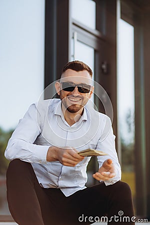 smiling man with money in hand. Businessman man in glasses Stock Photo