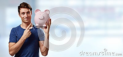 Smiling man with piggy bank. Stock Photo