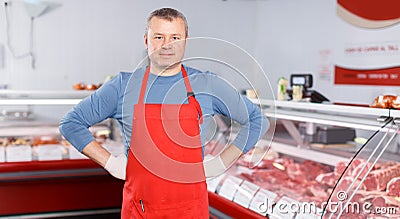 Smiling man seller offering products in shop Stock Photo
