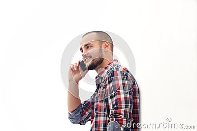 Smiling man with short hair and beard using mobile phone Stock Photo