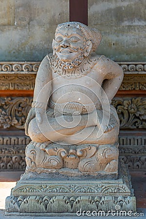 Smiling man statue at Batuan temple, Ubud, Bali Indonesia Stock Photo