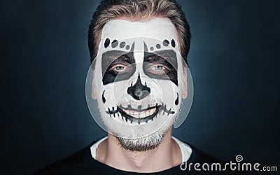 Smiling man with sugar skull makeup Stock Photo