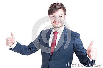 Smiling man in suit showing thumbs up Stock Photo