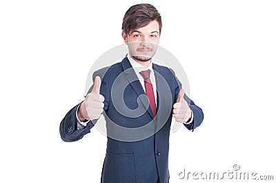 Smiling man in suit showing thumbs up Stock Photo