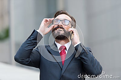 Smiling man talking on the phone and looking at the sky Stock Photo