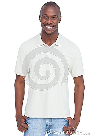 Smiling man with thumbs in pocket Stock Photo