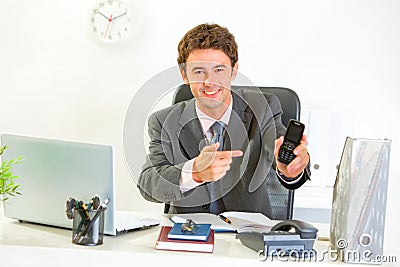Smiling manager pointing on mobile Stock Photo