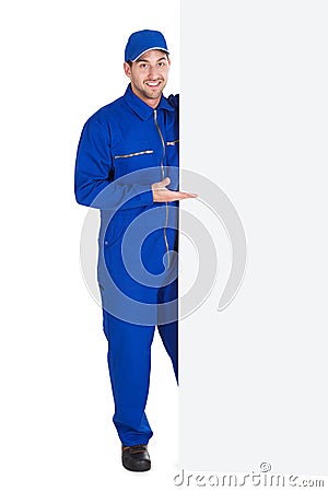 Smiling manual worker with billboard Stock Photo