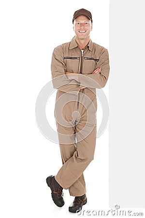 Smiling manual worker with billboard Stock Photo