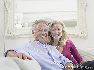 Smiling Mature Couple In White Home Interior Stock Photo