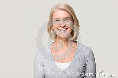 Smiling mature woman looking at camera isolated on grey background Stock Photo