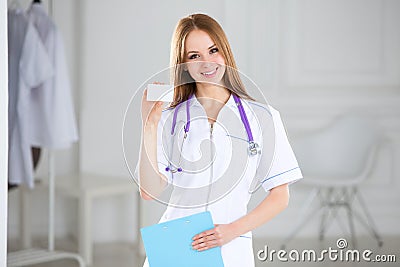 Smiling medical doctor showing business card sign, blank with copy space for text or design. Stock Photo