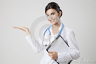 Smiling medical doctor woman with stethoscope. Present something Stock Photo