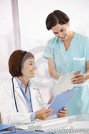 Smiling medical expertise working with assistant Stock Photo