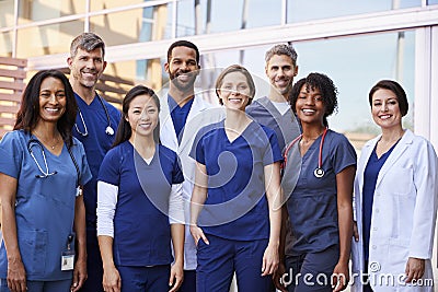 Smiling medical team standing together outside a hospital Stock Photo