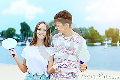 Young couple in love playing with matkot rackets Stock Photo