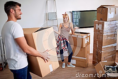 Man and woman packing moving boxes, ready for move out Stock Photo