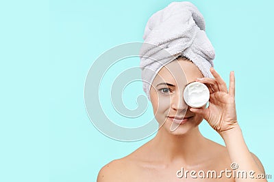 Smiling mid 30s woman holding moisturizing cream in front of her face. Beauty and Skincare concept. Stock Photo