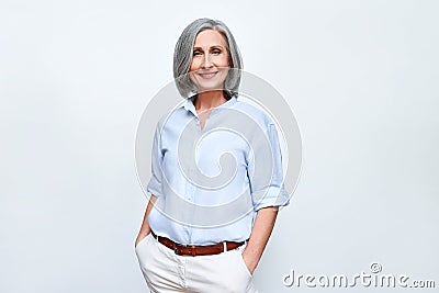 Smiling middle aged business woman standing isolated on white background. Stock Photo