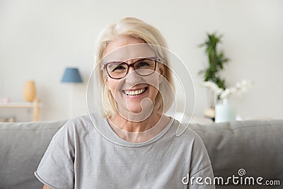 Smiling middle aged mature grey haired woman looking at camera Stock Photo