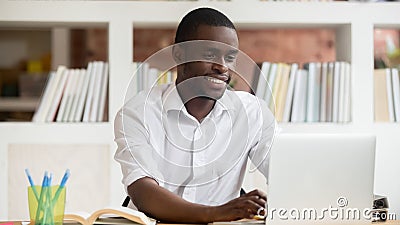 Happy black male student using apps study online on computer Stock Photo