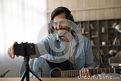 Smiling male artist compose music using smartphone Stock Photo