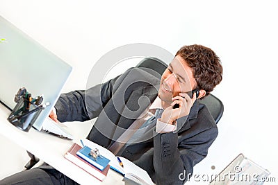 Smiling modern businessman talking on mobile Stock Photo