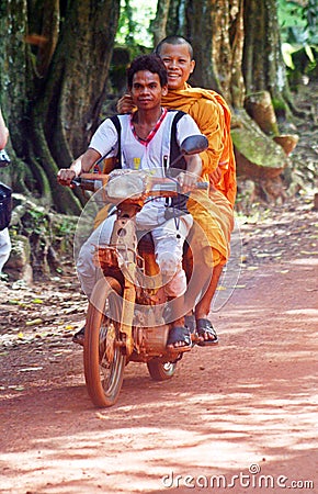 Smiling Monk on Motorbike - Cambodia Editorial Stock Photo