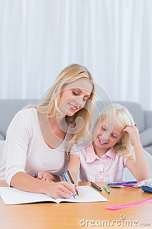 Smiling mother drawing with her daughter Stock Photo