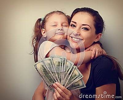 Smiling mother and happy cute daughter cuddling and showing doll Stock Photo