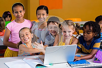 Smiling multi ethnic children using laptop Stock Photo