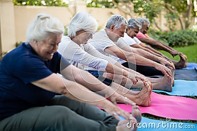 Smiling multi-ethnic senior people doing stretching exercise Stock Photo