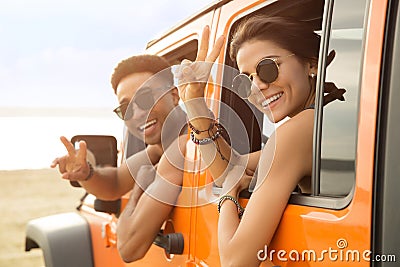 Smiling multiethnic couple sitting in a car Stock Photo