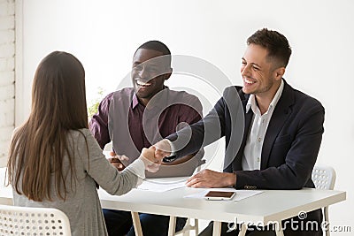 Smiling hr handshaking female applicant at job interview, hiring Stock Photo