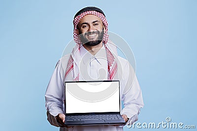 Muslim advertiser holding laptop Stock Photo