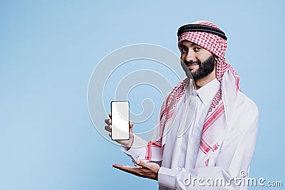 Muslim man presenting smartphone screen Stock Photo